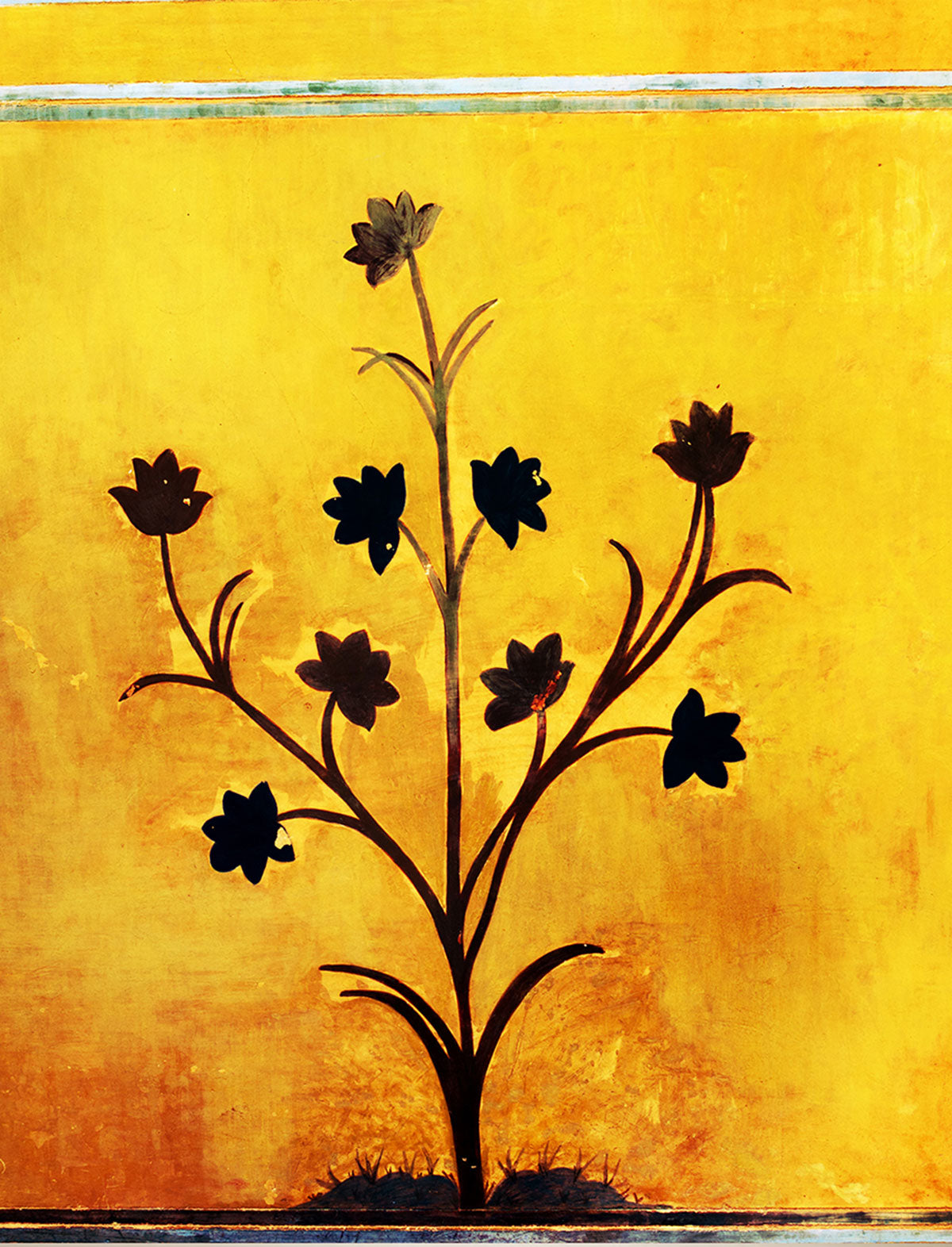 "Ancient Floral Painting Adorns Amber Fort Temple Wall in Rajasthan, India."