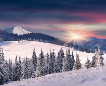 Winter Sunrise Over Snow-Covered Mountains