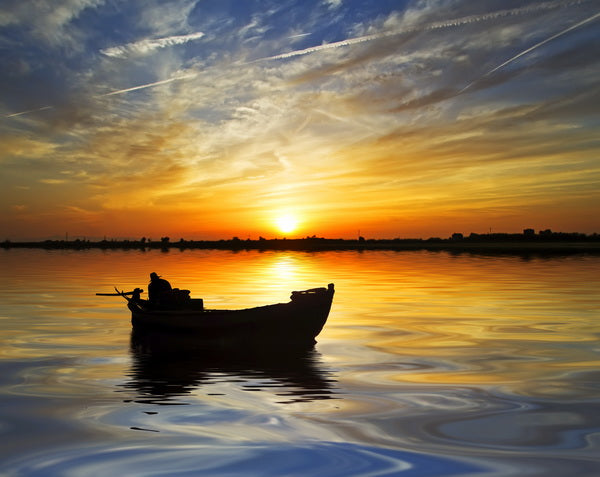 Serenity at Sunset: Solitary Boat on Golden Waters