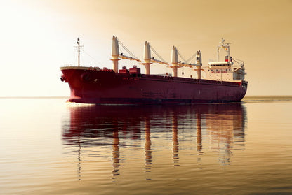 Cargo Ship at Sunrise on Calm Waters