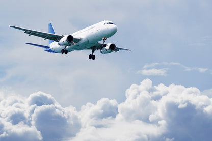 Airplane Descending Through Cloudy Sky