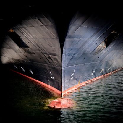 The Bow of a Ship in Shadowed Waters