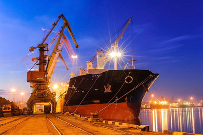 Cargo Ship Docked at a Port During Twilight