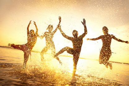 Joyful Sunset Splash: Friends Playing in the Water