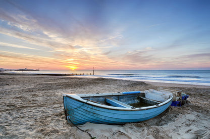 Abandoned Rowboat at Sunrise on the Beach