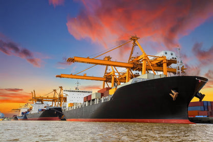 Cargo Ships at Sunset in a Busy Port