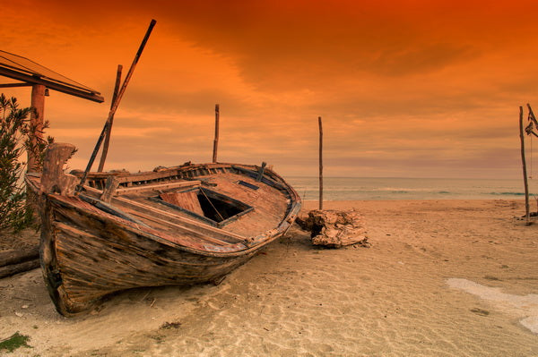 Abandoned Boat at Sunset on a Deserted Shore