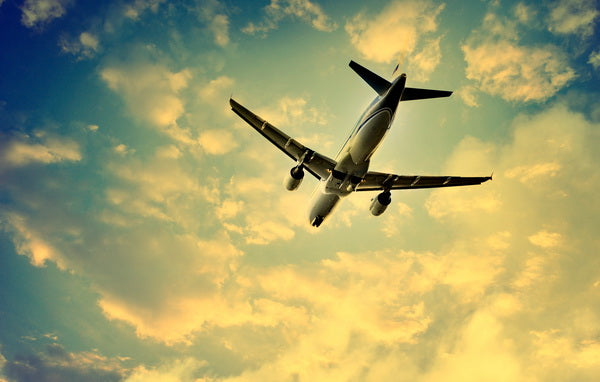 Airplane Flying at Sunset