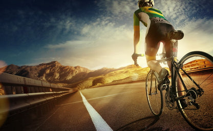 Cyclist on Mountain Road at Sunrise