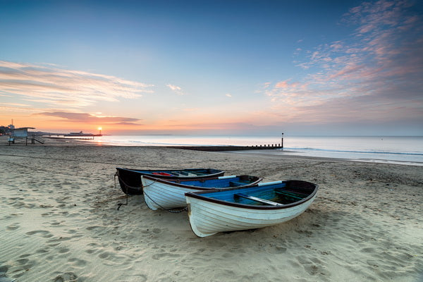 Serene Beachfront Scene with Rowboats at Sunset